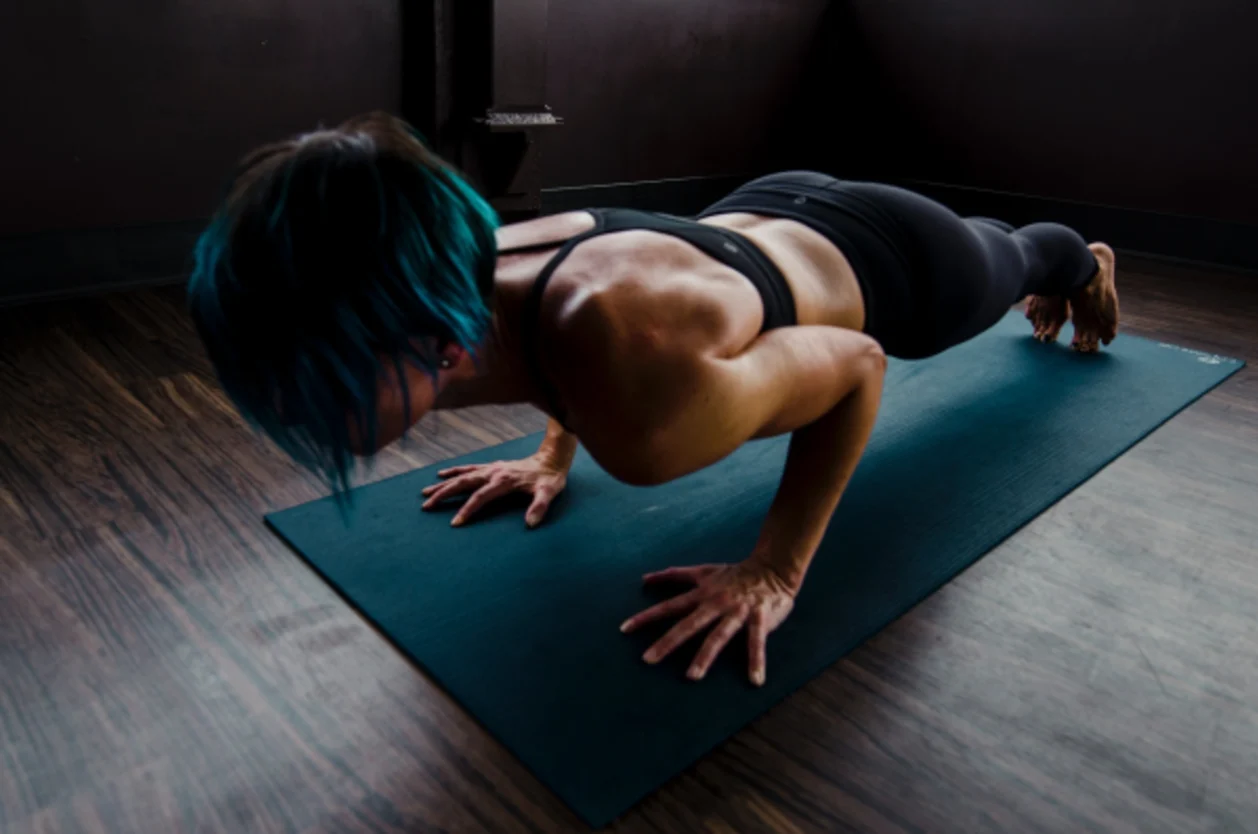 woman doing chaturanga what to wear on a wellness retreat